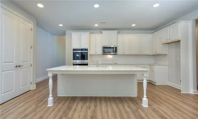 a view of kitchen with wooden floor and electronic appliances