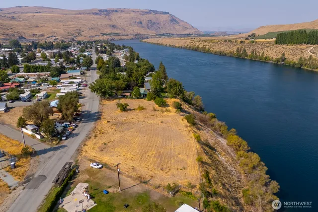 an aerial view of swimming pool with residential house in background