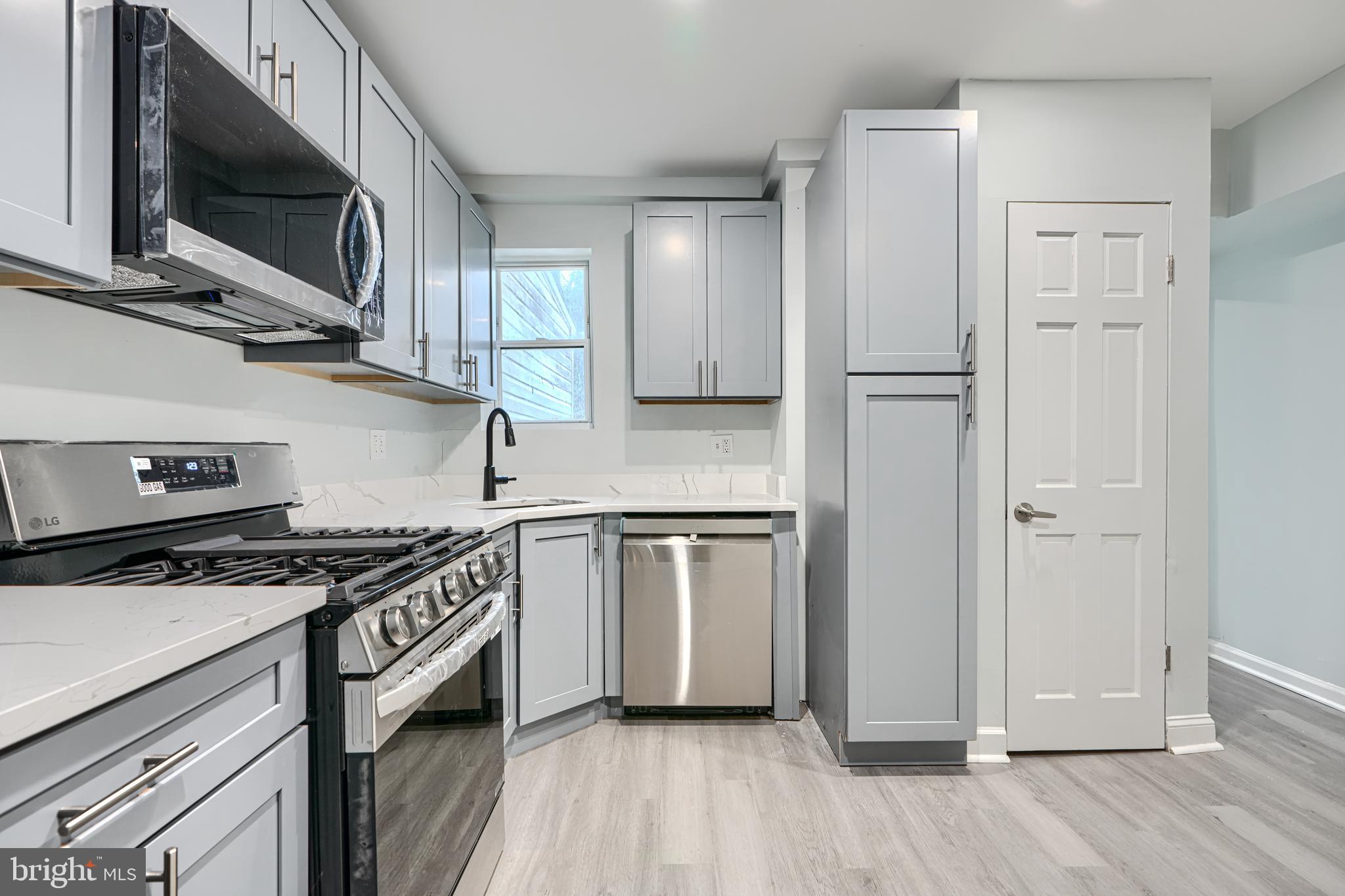 3606 Old York Road Baltimore, MD 21218 - Photo 15 of 35 a kitchen with stainless steel appliances granite countertop a stove a sink and a microwave