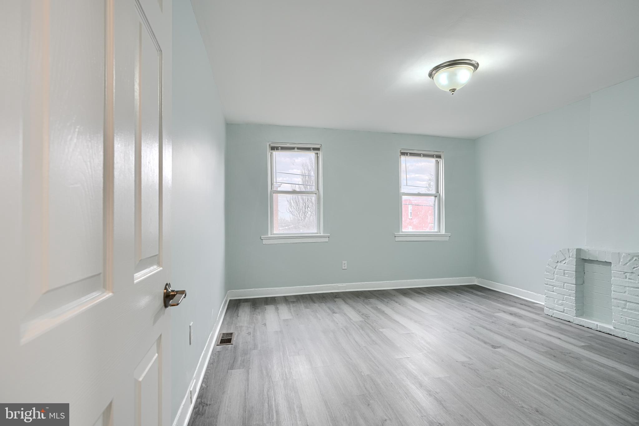 3606 Old York Road Baltimore, MD 21218 - Photo 20 of 35 an empty room with wooden floor and windows