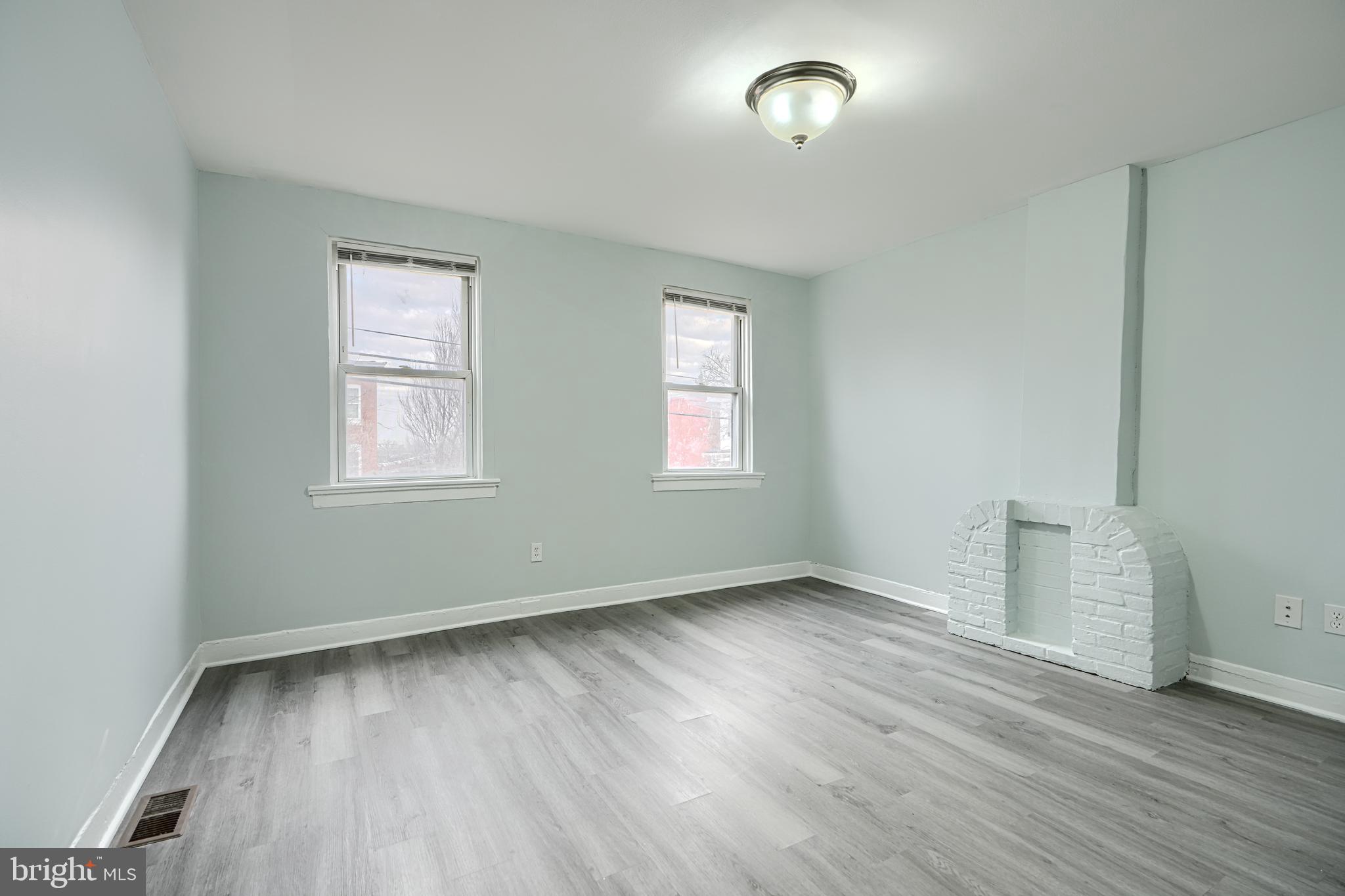 3606 Old York Road Baltimore, MD 21218 - Photo 21 of 35 an empty room with wooden floor and windows