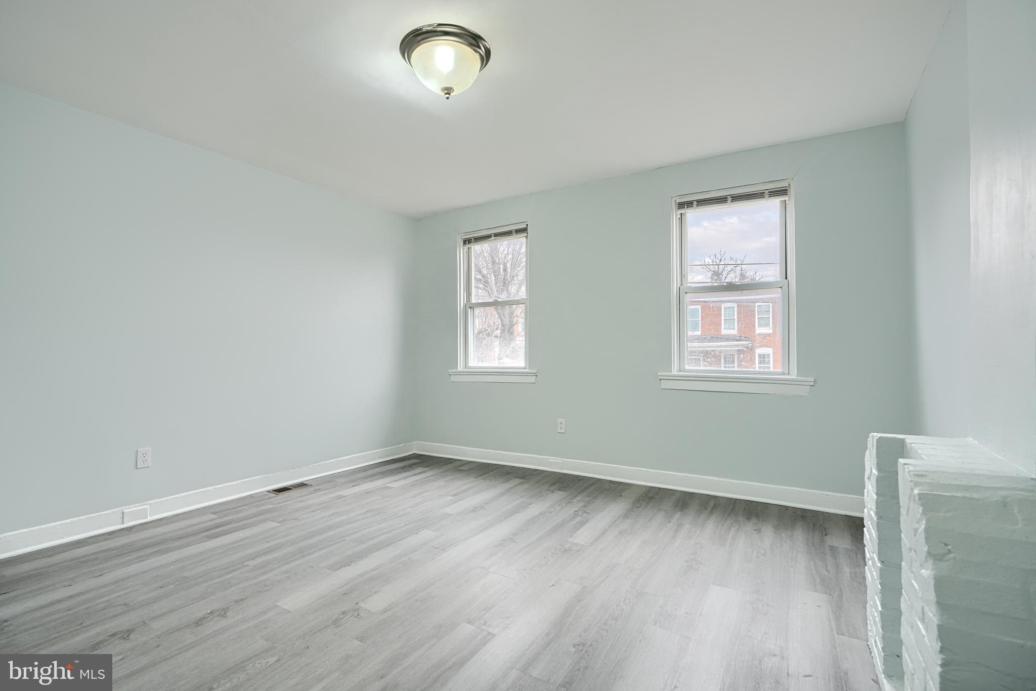 3606 Old York Road Baltimore, MD 21218 - Photo 22 of 35 an empty room with wooden floor and windows
