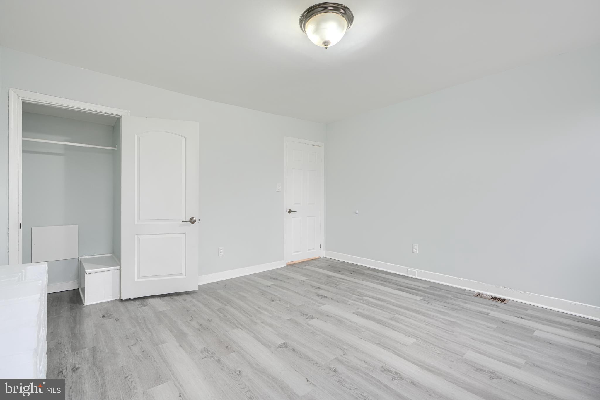 3606 Old York Road Baltimore, MD 21218 - Photo 24 of 35 an empty room with wooden floor and windows
