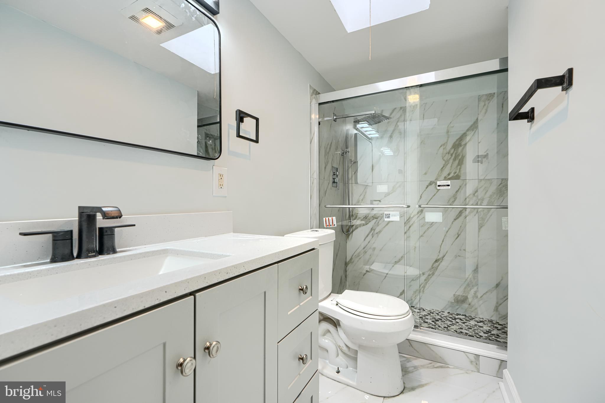 3606 Old York Road Baltimore, MD 21218 - Photo 28 of 35 a bathroom with a granite countertop sink a toilet and a shower