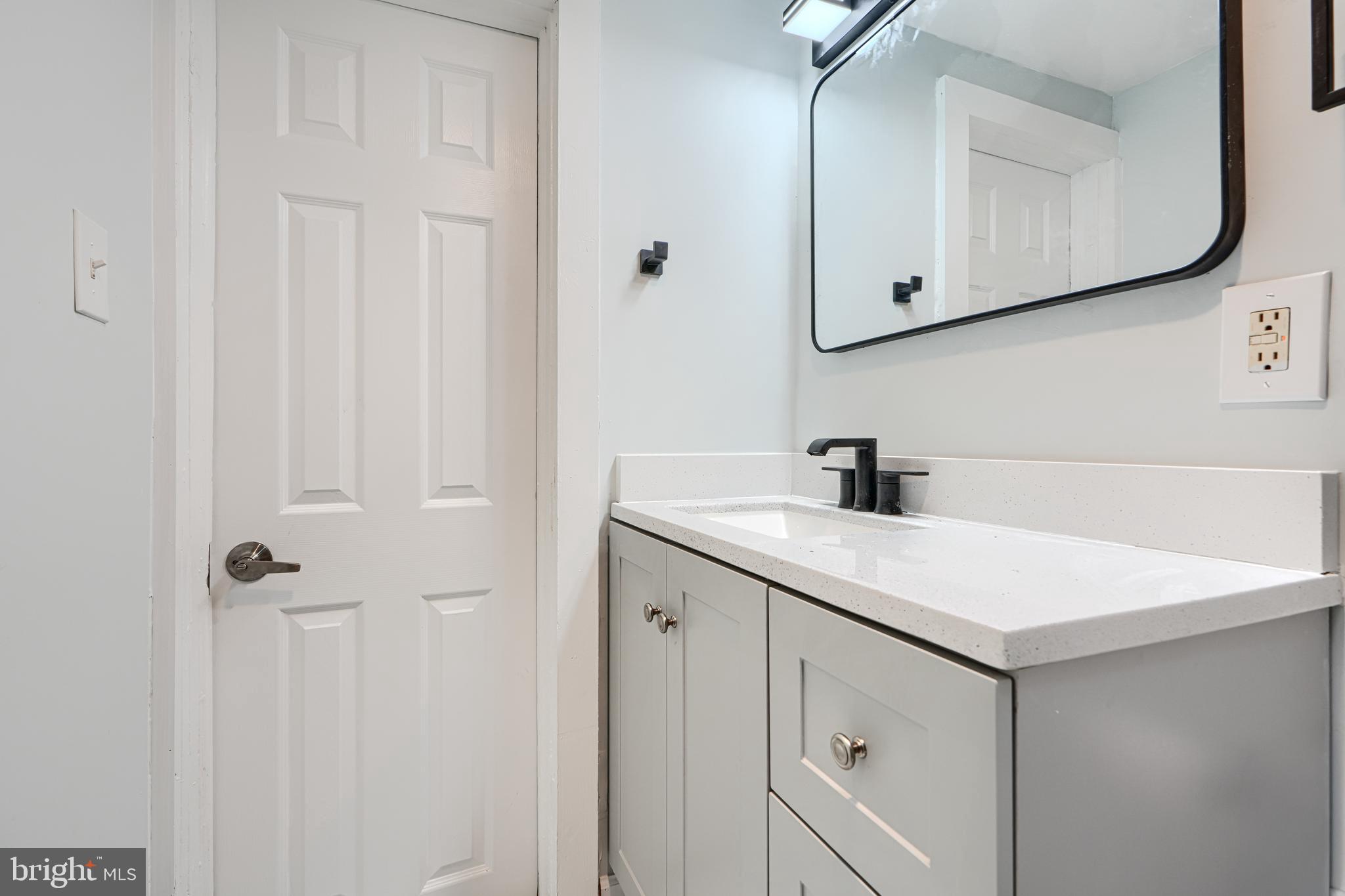 3606 Old York Road Baltimore, MD 21218 - Photo 30 of 35 a bathroom with a sink vanity and a mirror