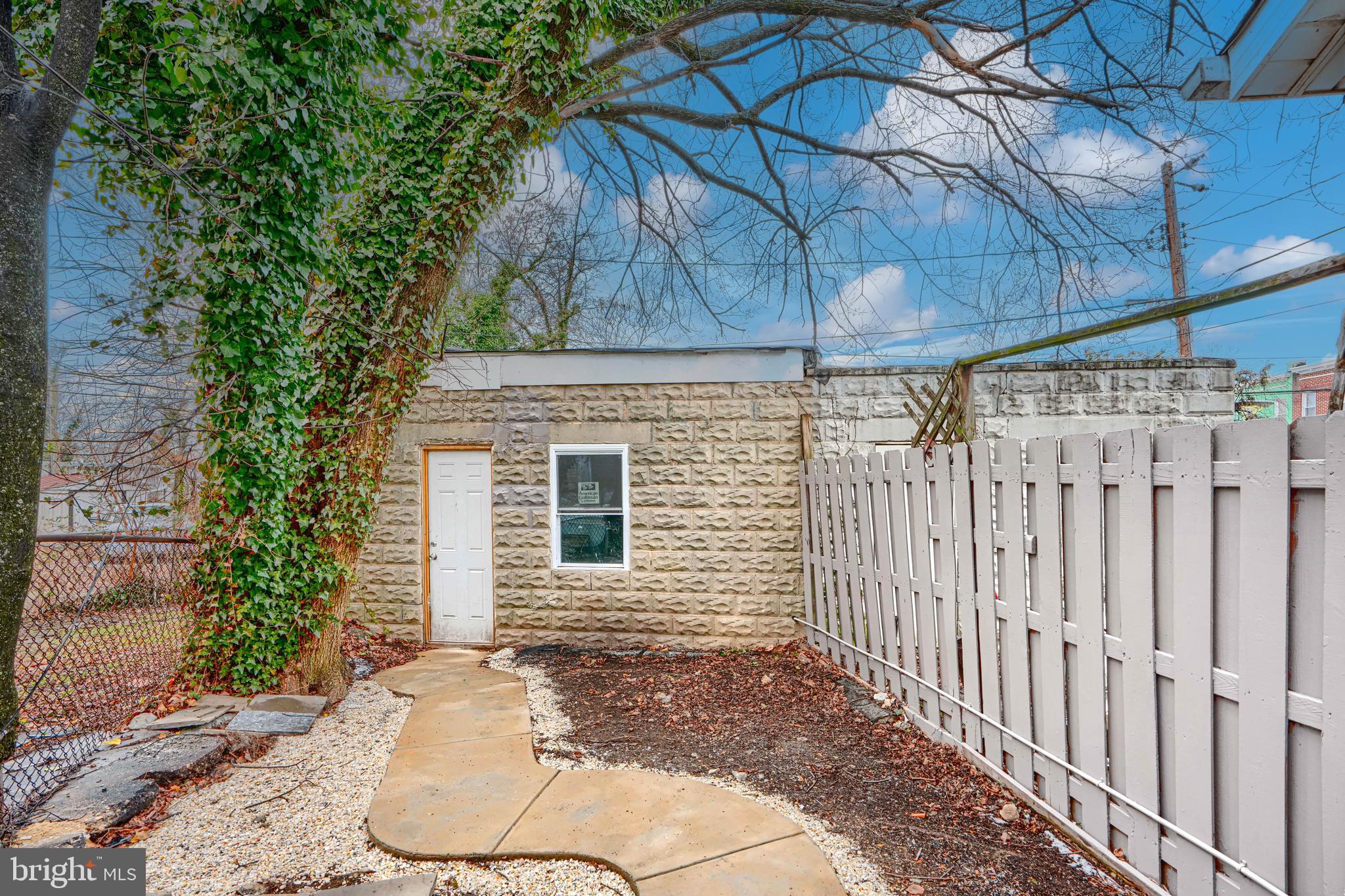 3606 Old York Road Baltimore, MD 21218 - Photo 31 of 35 a backyard of a house with table and chairs under an umbrella