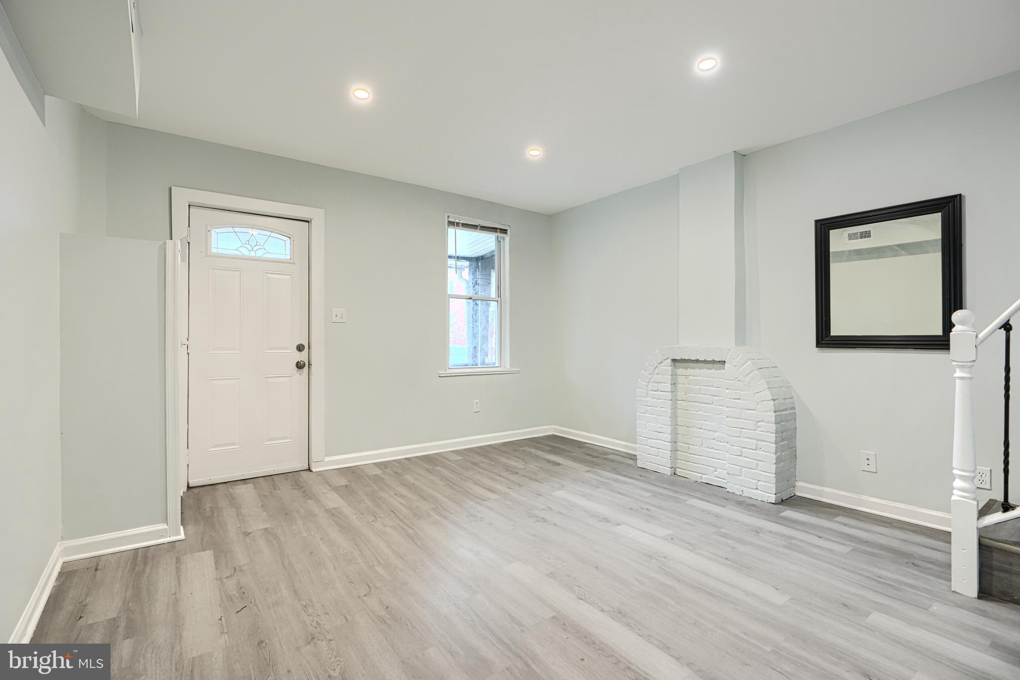 3606 Old York Road Baltimore, MD 21218 - Photo 9 of 35 an empty room with wooden floor and windows