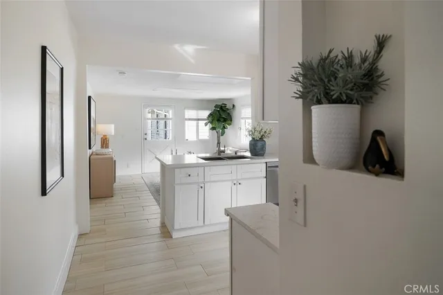 a living room with furniture a flat screen tv and kitchen view