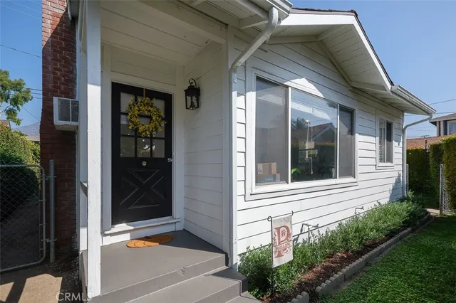 a backyard of a house with table and chairs
