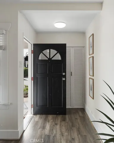 a dining room with furniture and wooden floor