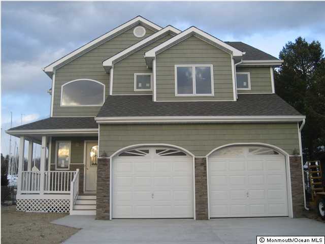 105 Cedar Run Road Bayville, NJ 08721 - Photo 1 of 3 a front view of a house with a garage