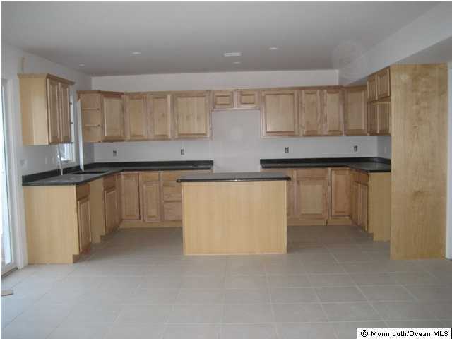 105 Cedar Run Road Bayville, NJ 08721 - Photo 3 of 3 a kitchen with stainless steel appliances a sink a stove a refrigerator a white cabinets and wooden floor