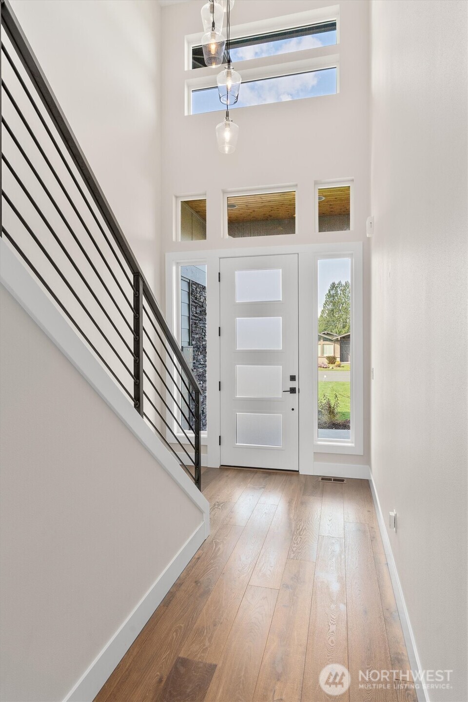 421 Rockefeller Avenue Everett, WA 98201 - Photo 17 of 40 a view of a hallway with wooden floor and staircase
