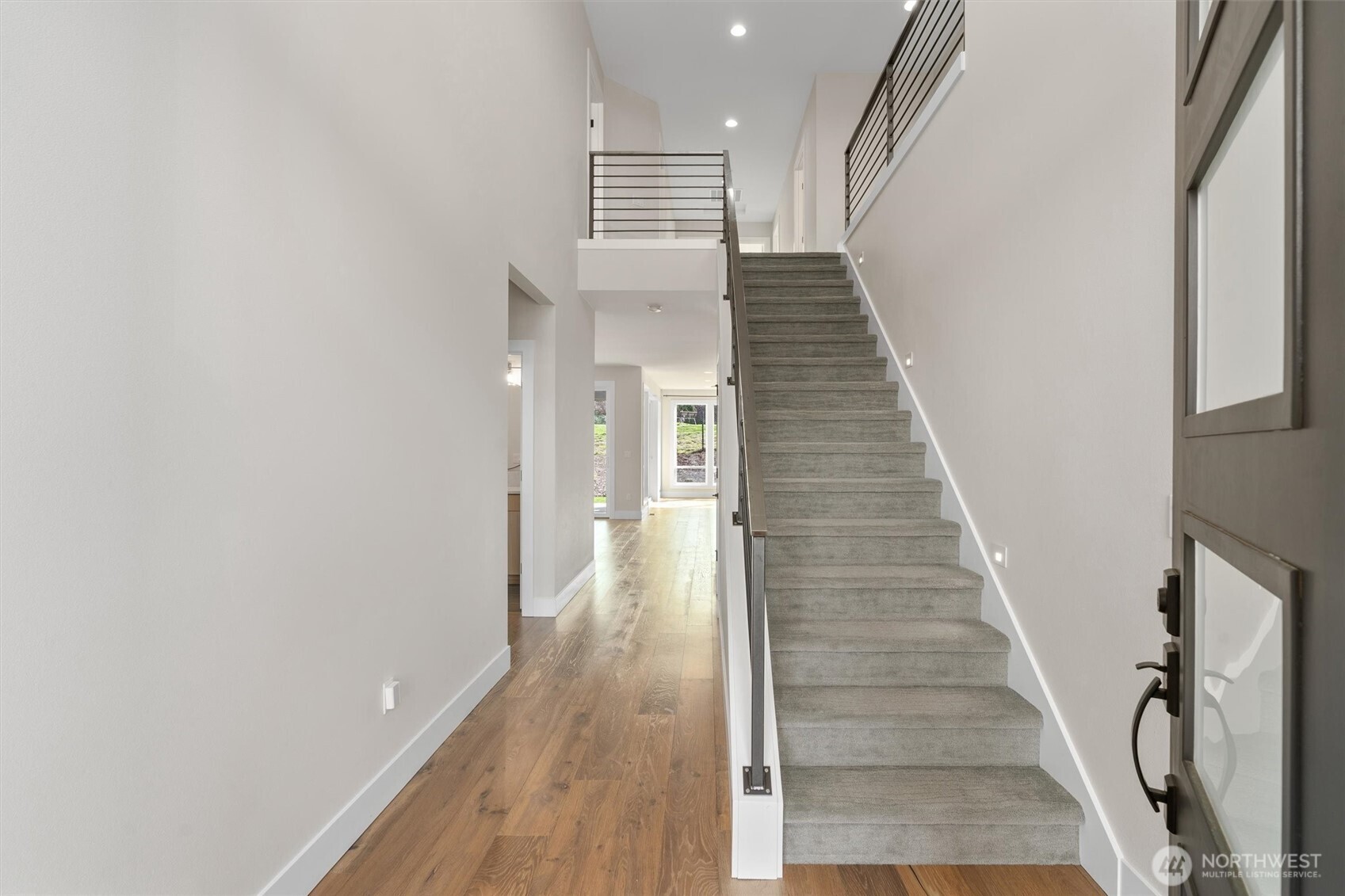 421 Rockefeller Avenue Everett, WA 98201 - Photo 4 of 40 a view of a hallway with wooden floor and staircase