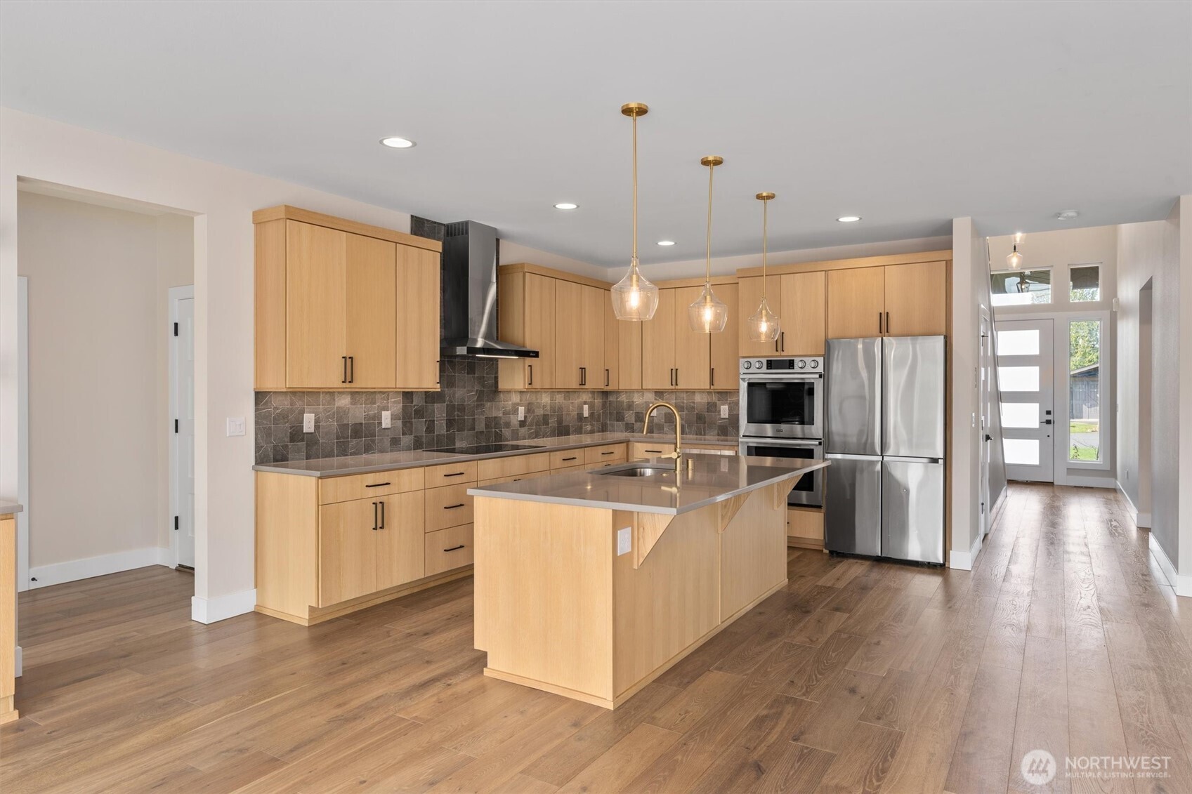 421 Rockefeller Avenue Everett, WA 98201 - Photo 6 of 40 a kitchen with stainless steel appliances granite countertop a refrigerator a sink dishwasher a stove and white cabinets with wooden floor