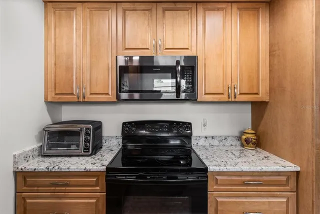 a living room with furniture a fireplace and paintings on the wall