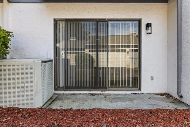 a view of backyard with wheel chair and potted plants