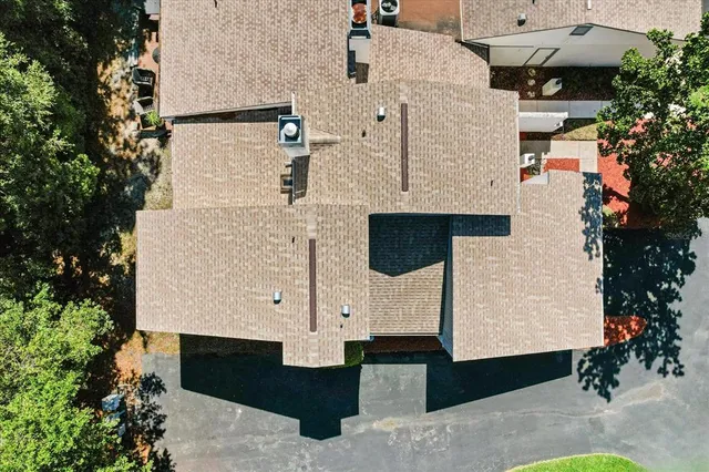 an aerial view of residential houses with city view