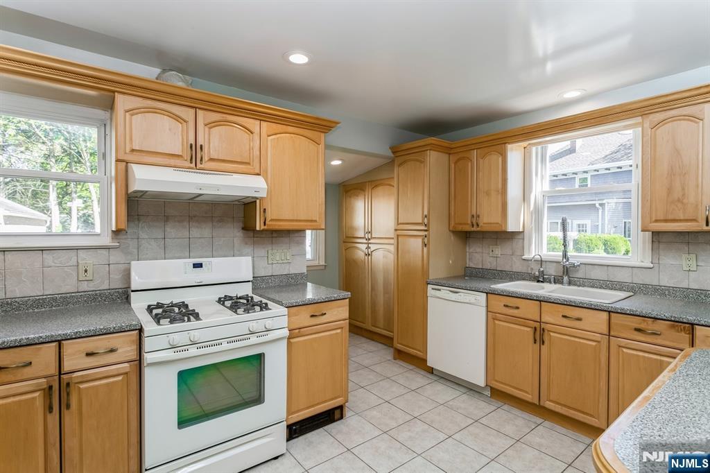 332 Closter Dock Road, Unit 1 Closter, NJ 07624 - Photo 3 of 21 a kitchen with stainless steel appliances granite countertop a stove sink and cabinets