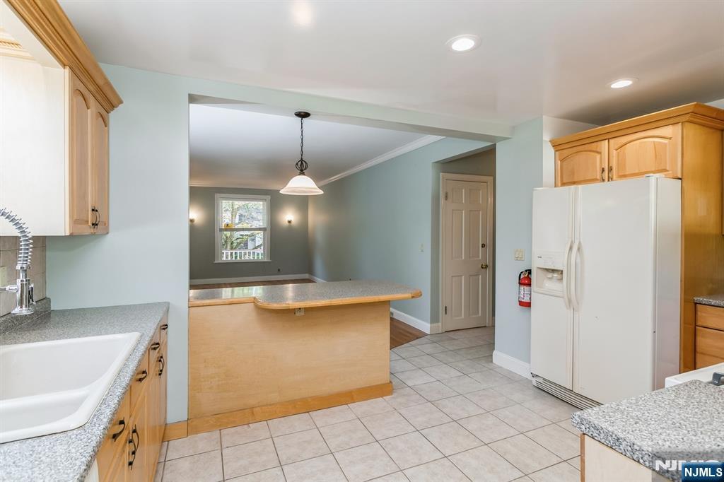 332 Closter Dock Road, Unit 1 Closter, NJ 07624 - Photo 4 of 21 a kitchen with stainless steel appliances a refrigerator and a sink