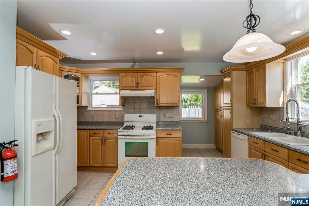 332 Closter Dock Road, Unit 1 Closter, NJ 07624 - Photo 5 of 21 a kitchen with stainless steel appliances granite countertop a sink a stove a refrigerator and a refrigerator