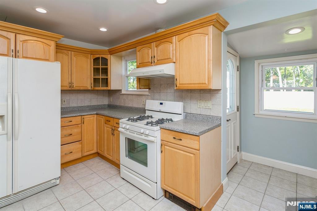 332 Closter Dock Road, Unit 1 Closter, NJ 07624 - Photo 6 of 21 a kitchen with stainless steel appliances granite countertop a stove a refrigerator and a refrigerator