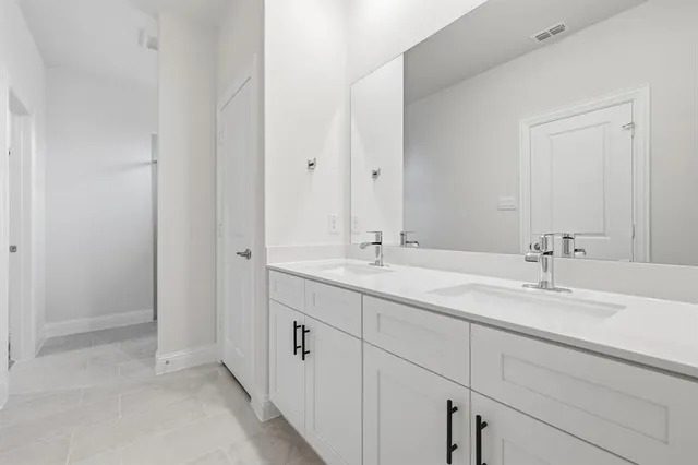 a bathroom with 2 sink and a mirror