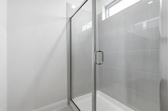 a bathroom with a glass shower door
