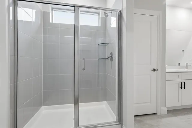 a bathroom with a glass shower door