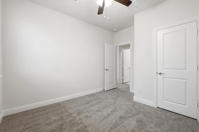 an empty room with ceiling fan