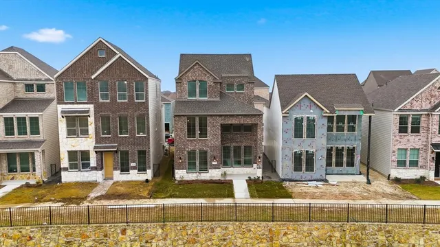 a view of multiple houses with a yard