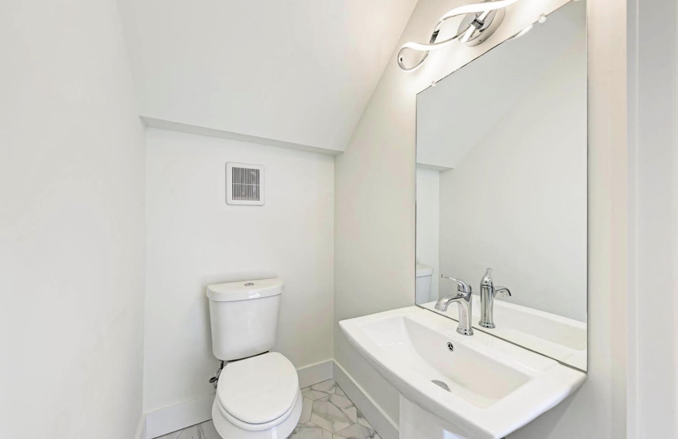 502 Tillery Street, Unit 2 Austin, TX 78702 - Photo 7 of 15 a bathroom with a toilet a sink and mirror