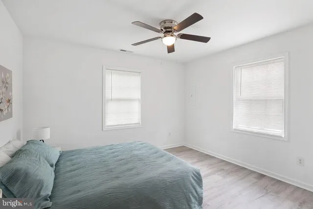a bed sitting in a bedroom next to a window