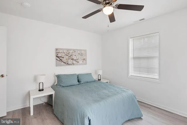 a bedroom with a large bed and a window