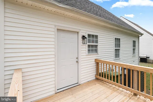 a view of a house with wooden deck