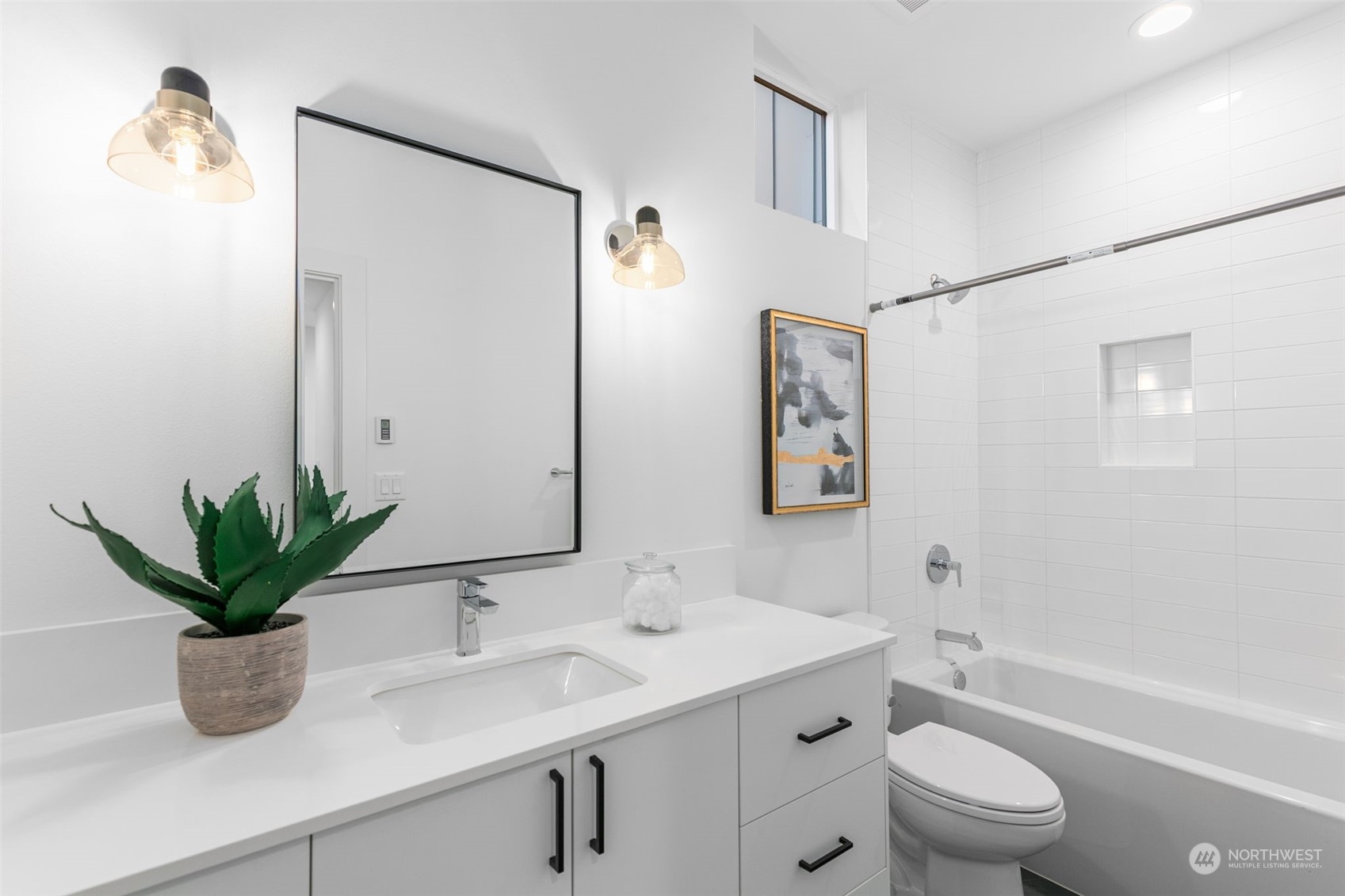 406 Northeast 75th Street Seattle, WA 98115 - Photo 16 of 29 a bathroom with a granite countertop sink a toilet a mirror and shower
