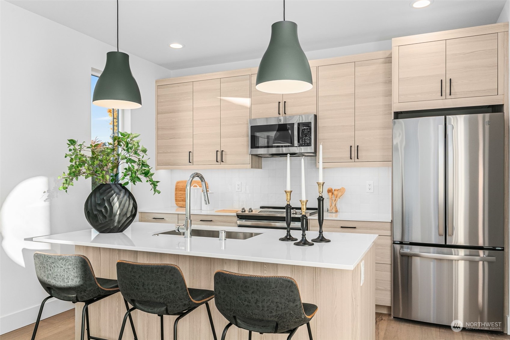 406 Northeast 75th Street Seattle, WA 98115 - Photo 8 of 29 a kitchen with stainless steel appliances a dining table chairs refrigerator and sink