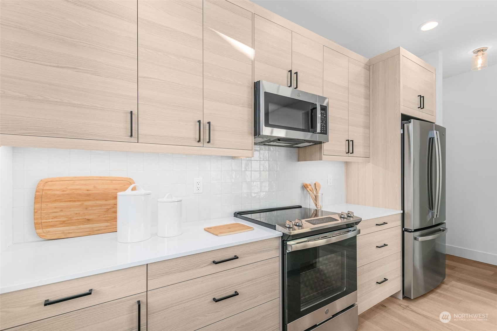 406 Northeast 75th Street Seattle, WA 98115 - Photo 9 of 29 a kitchen with stainless steel appliances white cabinets and a stove