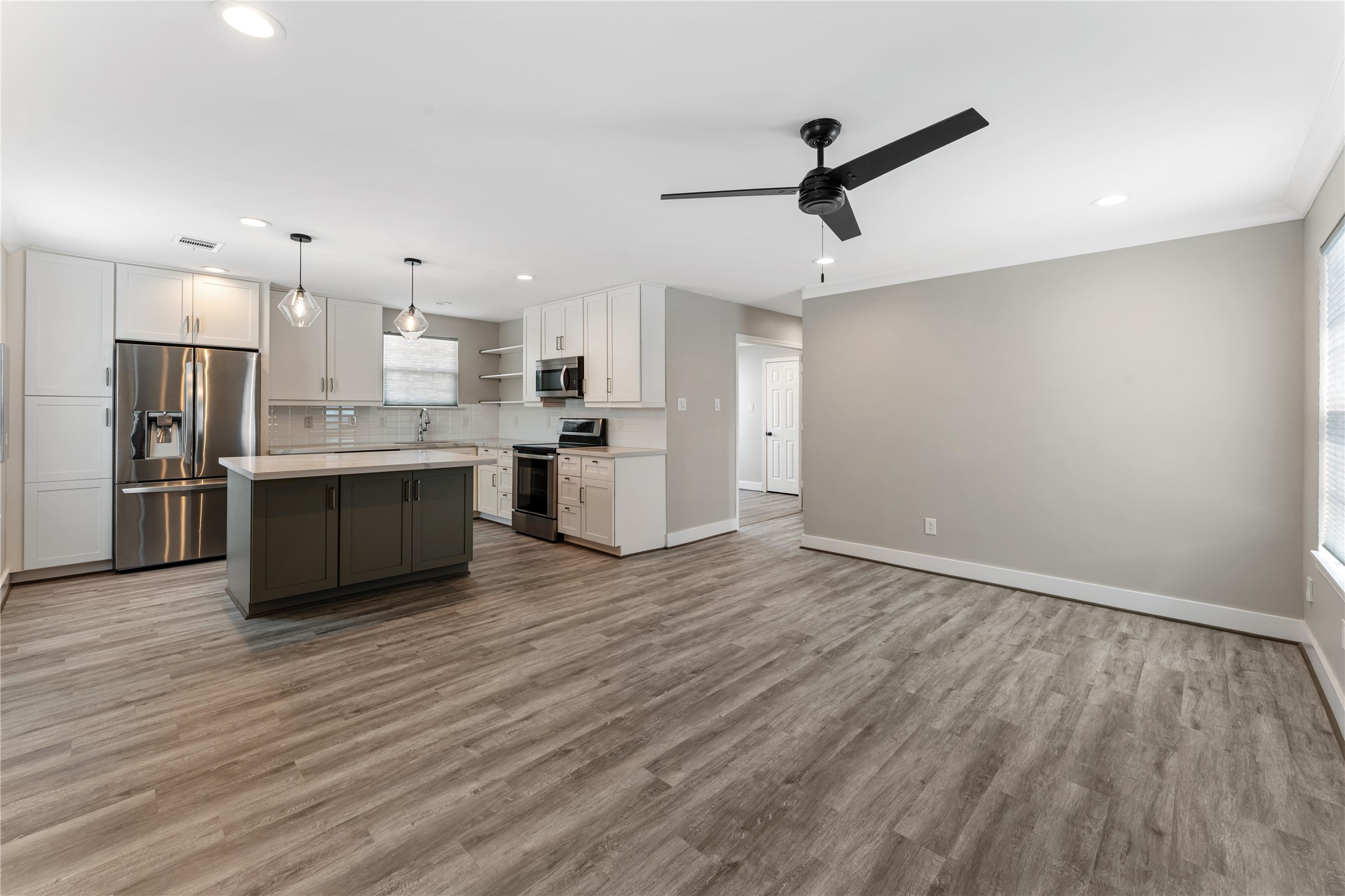 809 East 40th Street Houston, TX 77022 - Photo 11 of 33 Spacious open living area with modern finishes, updated ceiling fan, and clean lines throughout.