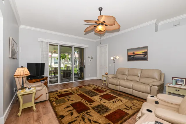 a view of a house with a yard and a large tree