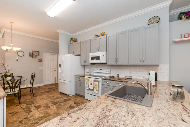 a view of a house with a yard and palm trees