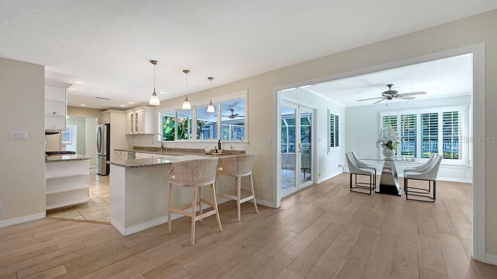 4810 Bay Shore Road Sarasota, FL 34234 - Photo 11 of 47 a dining room with furniture and wooden floor