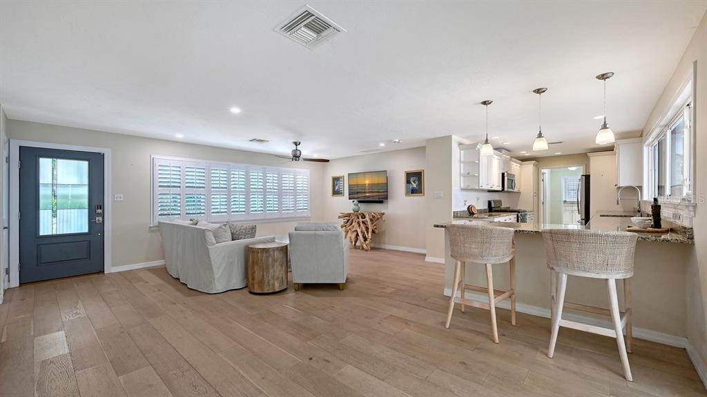 4810 Bay Shore Road Sarasota, FL 34234 - Photo 12 of 47 a large white kitchen with a table and chairs