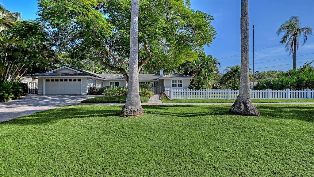 4810 Bay Shore Road Sarasota, FL 34234 - Photo 2 of 47 a view of a house with a big yard and palm trees