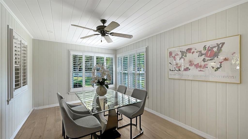 4810 Bay Shore Road Sarasota, FL 34234 - Photo 21 of 47 a view of a dining room with furniture window and wooden floor