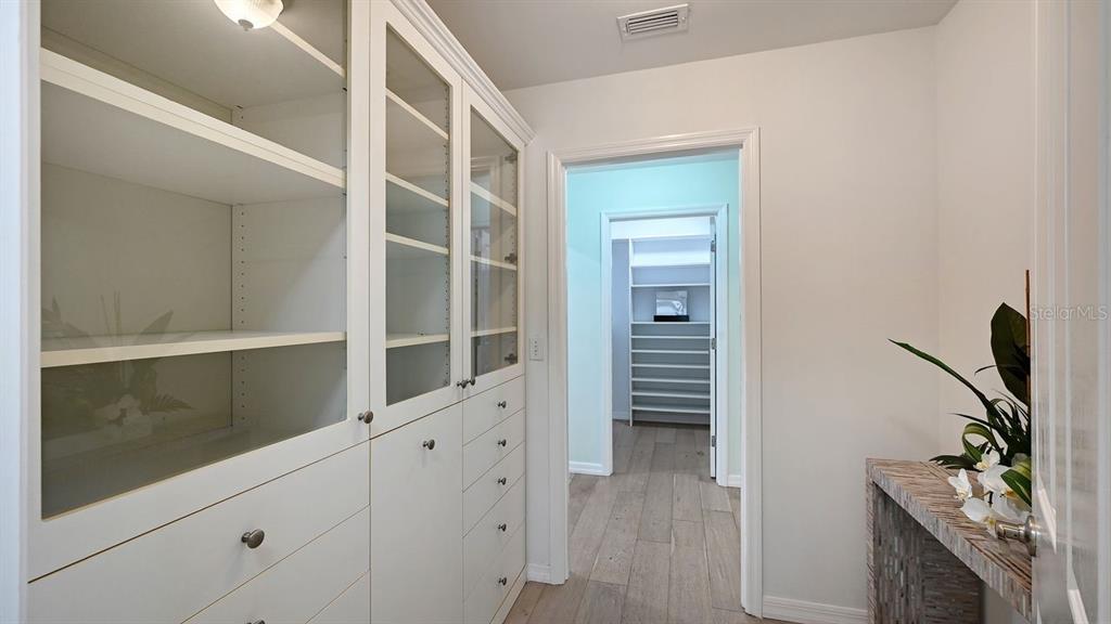 4810 Bay Shore Road Sarasota, FL 34234 - Photo 28 of 47 a room with a walk in closet and wooden floor