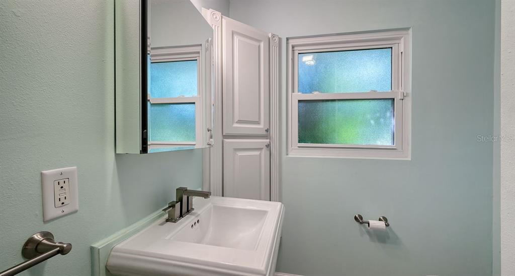 4810 Bay Shore Road Sarasota, FL 34234 - Photo 33 of 47 a bathroom with a sink and a mirror