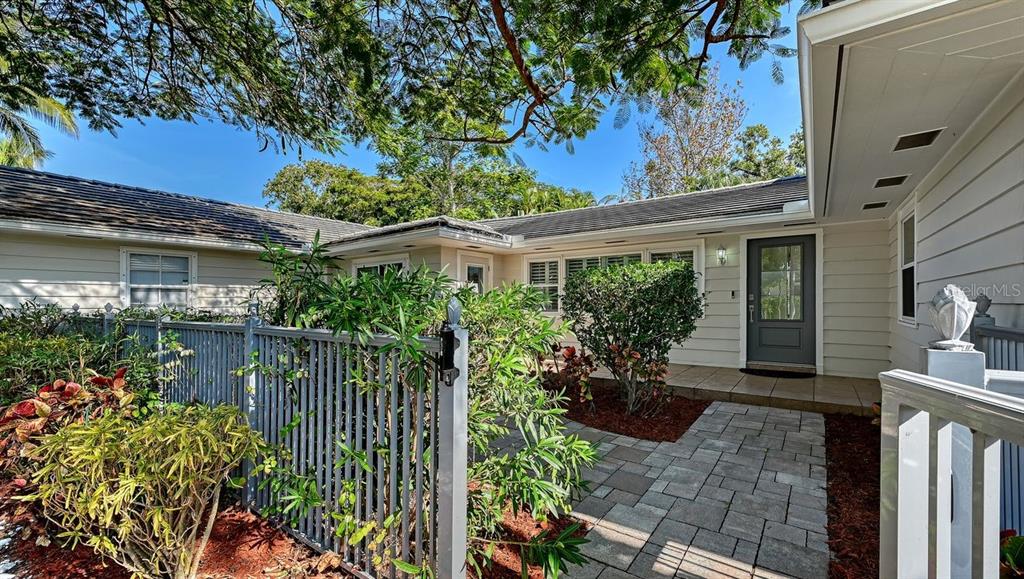 4810 Bay Shore Road Sarasota, FL 34234 - Photo 6 of 47 a house with a flower garden in front of it