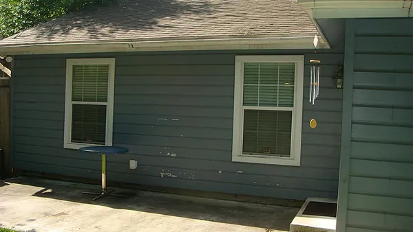 a view of house with window and wooden fence
