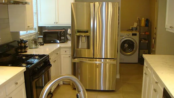 a kitchen with a refrigerator and a stove top oven